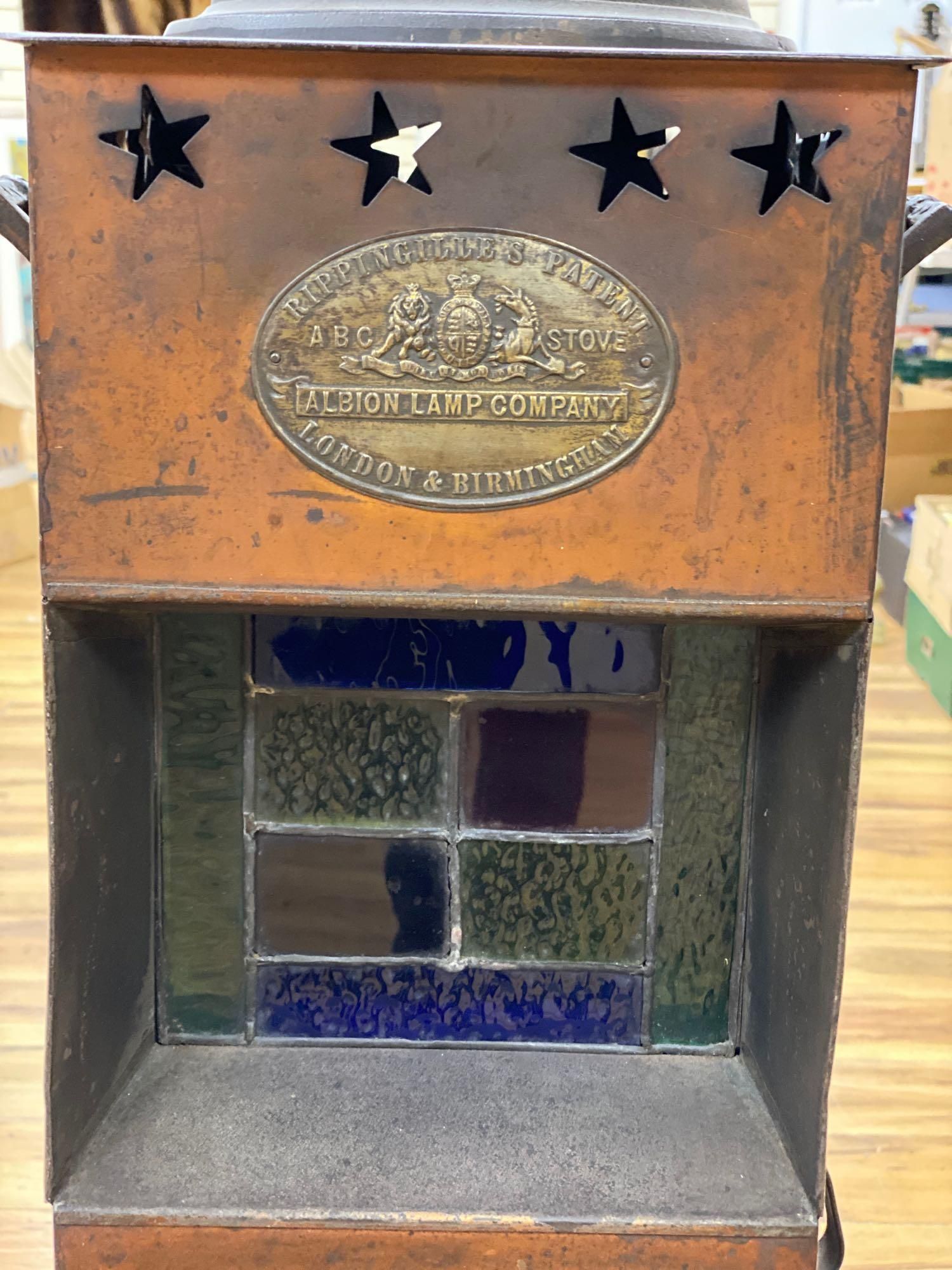 A Rippingilles Patent ABC Stove, Albion Lamp Co., oxidised copper frame, with leaded stained glass panel, circa 1860, 64cm high